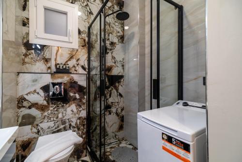 a bathroom with a shower and a toilet and a sink at Infinity house kavala in Kavala