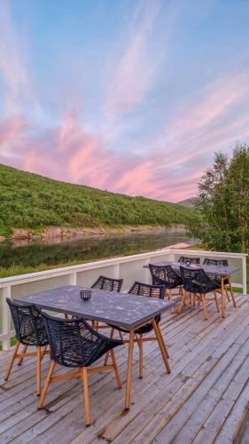 a group of tables and chairs on a deck at Levajok Lodge in Tana