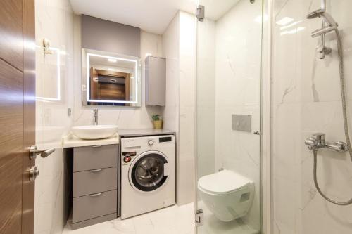 a bathroom with a washing machine and a sink at Stylish Flat with Central Location in Sisli in Istanbul