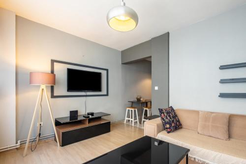 a living room with a couch and a flat screen tv at Amazing Flat With Excellent Location in Besiktas Istanbul in Istanbul