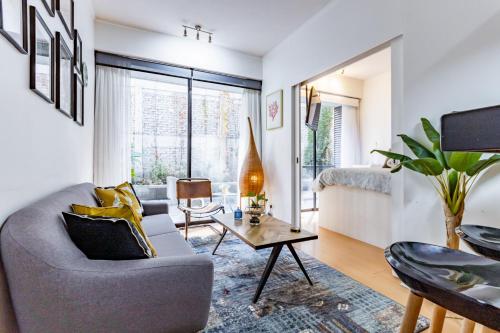 a living room with a couch and a table at San Carlos rentals - Lastarria in Santiago