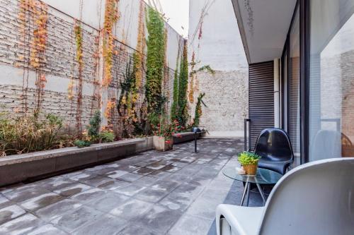 a courtyard with chairs and plants on a building at San Carlos rentals - Lastarria in Santiago