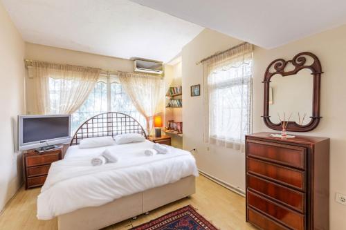 a bedroom with a bed and a mirror and a television at Uniq in Istanbul