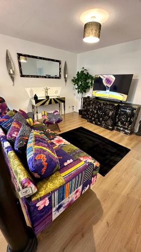 a living room with a couch and a stage at Stylish & Cosy - Flat 6, Osborne Road in Pontypool