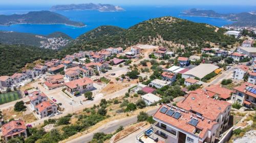 an aerial view of a town with mountains and the ocean at Luxury Flat with Jacuzzi in Kas in Kas