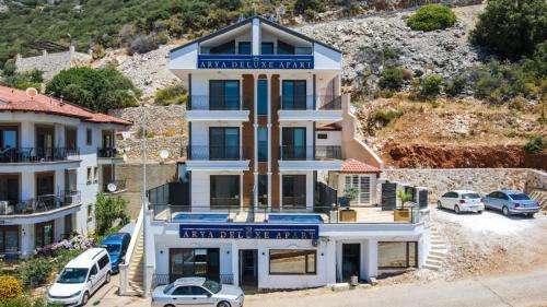 an apartment building with cars parked in a parking lot at Luxury Flat with Jacuzzi in Kas in Kas