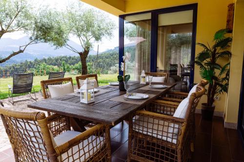 a wooden table and chairs on a patio at Boavista Country Houses no 93 in Vila Nune