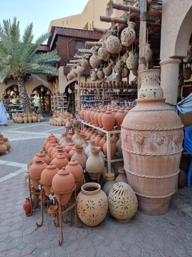 a group of clay vases on display in a store at بيت الراحة Rest House in Nizwa