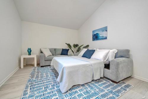a living room with a bed and a couch at Lagoon 2623 by Nautical Properties in Panama City Beach