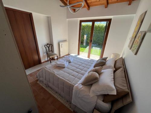 a bedroom with a large bed and a large window at B&B La cas' d'Alfonz' in Sulmona