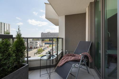 a balcony with a chair and a view of a street at City Centre & Modern Apartment with Parking by Renters Prestige in Krakow