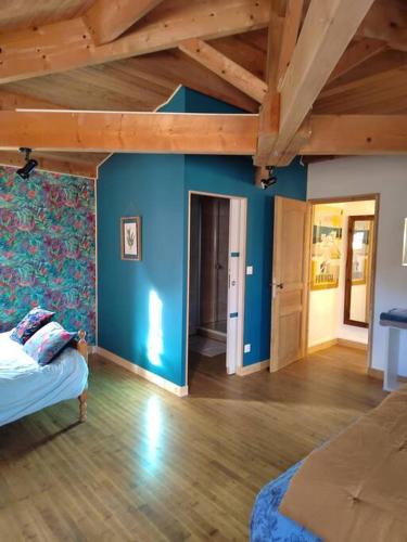 - une chambre aux murs bleus et un lit dans un dortoir dans l'établissement Moulin de Pisseloube, à Montchaude