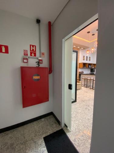 a room with a red fire hydrant on the wall at Apart Hotel Seg Total Lofts Encantadores in Mogi-Guaçu