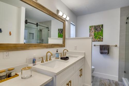 a bathroom with a sink and a mirror at Beachy Cape Coral Home - Swim, Fish, Boat! in Cape Coral