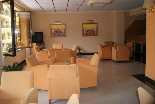 a waiting room with orange chairs and a tv at Rosabel in Benidorm