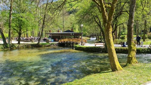 a bridge over a river in a park at Villa FARAH Sarajevo in Sarajevo