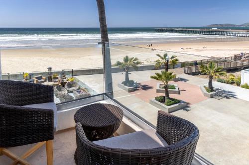 a view of the beach from the balcony of a resort at Sandcastle Hotel on the Beach in Pismo Beach
