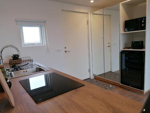 a kitchen with a sink and a counter top at Blackwood cottage near Geysir in Reykholt