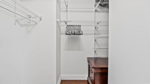 a room with white walls and a desk and chandelier at Luxurious 4 BR Penthouse in NYC in New York