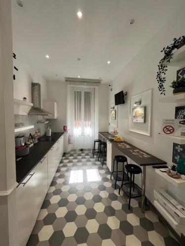 a kitchen with a black and white checkered floor at Domus Giordano in Rome