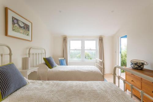 a bedroom with two beds and a window at Bowden Retreats in Dartmouth
