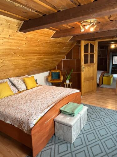 - une chambre avec un lit et un plafond en bois dans l'établissement Vidiecky dom AlexSandra - ubytovanie v súkromí, à Liptovská Ondrašová