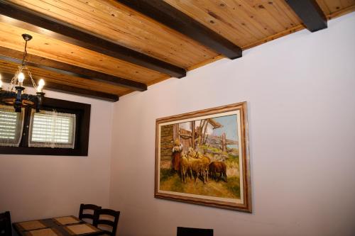 a painting of horses on a wall in a room at Hotel Restaurant Dreri in Tirana