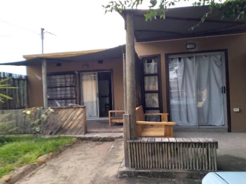 a house with a bench in front of it at Kadavu Accommodations in Maun