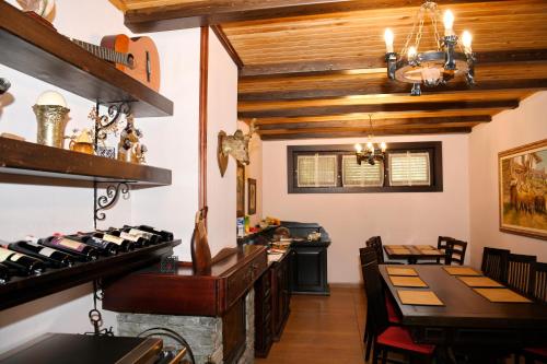 a restaurant with wooden ceilings and a table and chairs at Hotel Restaurant Dreri in Tirana