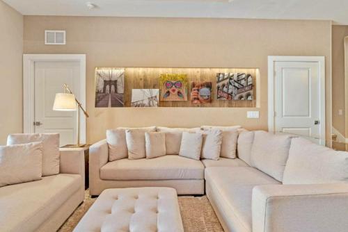 a living room with a white couch and a table at Beautiful 4 suites - Close to Disney 7505 in Orlando
