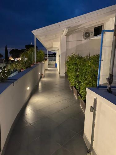 a walkway with lights on the side of a building at B&B Dionea in Santa Maria di Castellabate