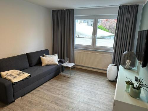 a living room with a couch and a window at Steinweg 7 Ferienwohnung in Kassel