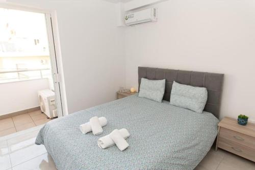 a bedroom with a bed with two crosses on it at Fully equipped flat in Piraeus (Erm_C7) in Piraeus