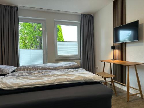 a hotel room with two beds and a television at Steinweg 7 Ferienwohnung in Kassel