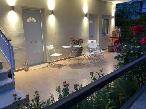 a patio with chairs and a table on a house at NG Luxury Apartments at Nea Kallikrateia No 1 in Nea Kalikratia