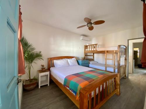 a bedroom with a bed and a bunk bed at JAKES ON THE BEACH in Las Peñitas
