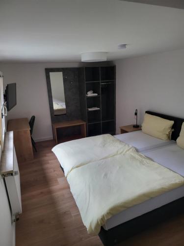a bedroom with two beds and a mirror at Hotel CASA ITALIA in Bamberg