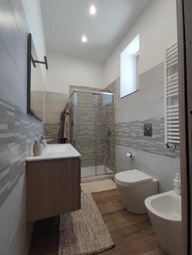 a bathroom with a shower and a sink and a toilet at Country House Ortensie in Torre del Greco