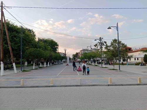 a group of people walking down a street at N G Luxury Apartments at Nea Kallikrateia No 2 in Nea Kalikratia