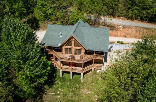 an overhead view of a log home with a green roof at Quiet Haven Mountain Top Cabin - 3 Bedroom Cabin with Breathtaking Views in Topton