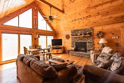 a living room with leather furniture and a fireplace at Quiet Haven Mountain Top Cabin - 3 Bedroom Cabin with Breathtaking Views in Topton