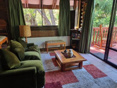 a living room with a couch and a coffee table at Casa Ayllantú in Las Trancas