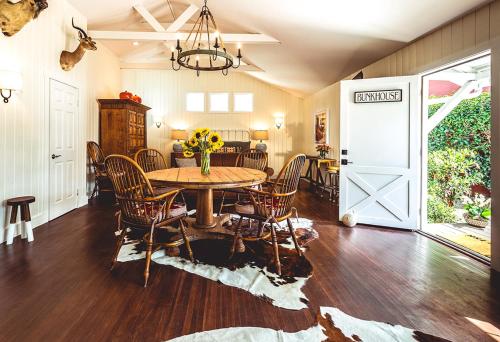 a dining room with a table and chairs and a door at Stables Inn in Paso Robles