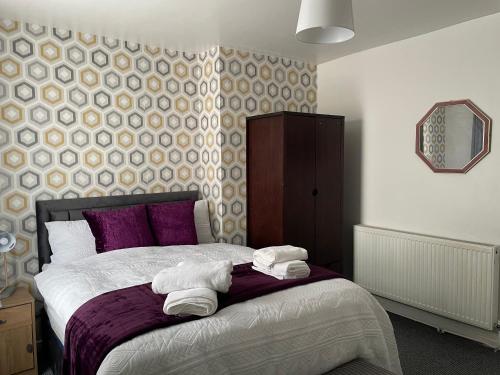 a bedroom with a bed with two towels on it at Luxury Spacious 2 Bedroom Home. in Liverpool