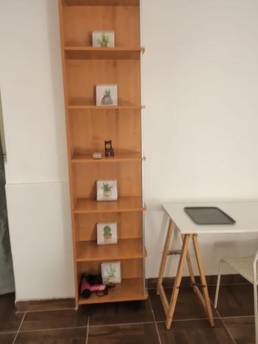 a book shelf next to a desk and a table at Casa Castelli in Messina