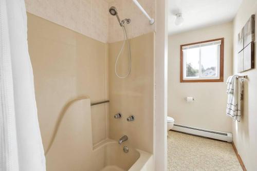 a bathroom with a shower and a tub and a toilet at WALK to West Point Academy! Charming 2 bdrm Apt overlooking Main Street! in Highland Falls