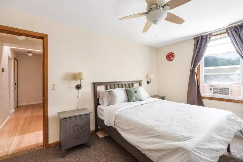 a bedroom with a bed and a ceiling fan at WALK to West Point Academy! Charming 2 bdrm Apt overlooking Main Street! in Highland Falls
