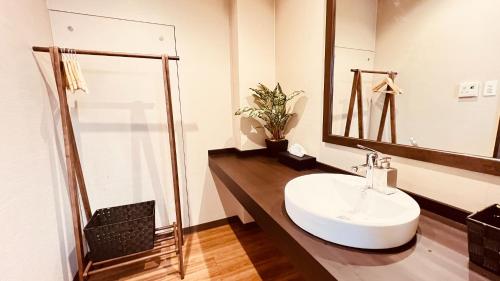 y baño con lavabo blanco y espejo. en Shiki Building 5th Floor 6th Floor - Vacation STAY 62606v, en Naha