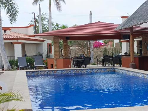 a swimming pool in front of a house at GoBaja Villas 2 bedroom in La Paz