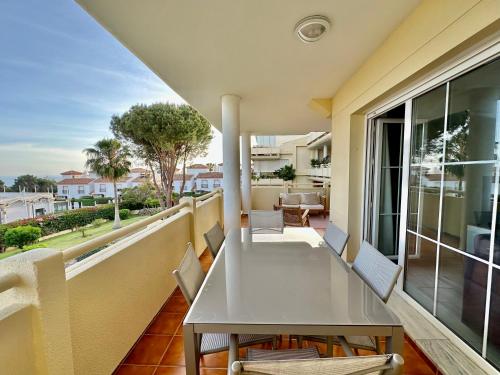 a balcony with a white table and chairs on a balcony at Seaview and big terrace Cabopino in Marbella